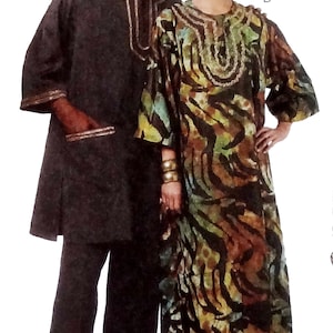 May include: A couple wearing traditional African clothing. The woman is wearing a long, flowing dress with a colorful animal print pattern. The man is wearing a long-sleeved shirt and pants. Both are wearing head coverings.