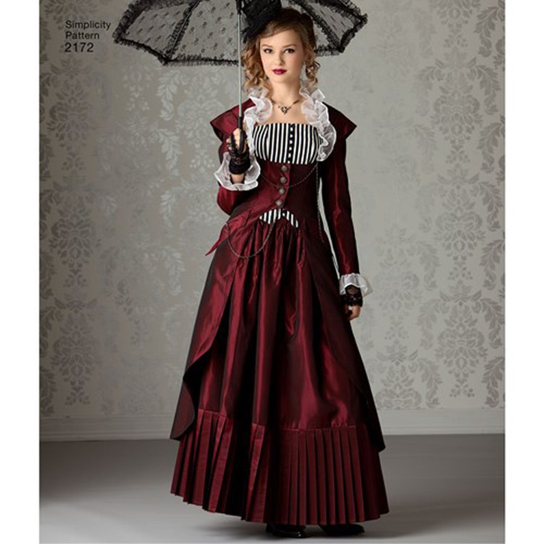 May include: A burgundy steampunk-style dress with a long skirt and a fitted bodice. The bodice features a black and white striped panel and a ruffled collar. The dress is accessorized with a black lace parasol and a small hat. The pattern number is 2172.