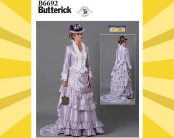 May include: A sewing pattern for a historical dress, featuring a lilac-colored gown with a ruffled skirt and a matching jacket. The pattern includes a smaller image of the dress from the back. The pattern is labeled "B6692 Butterick".