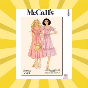 May include: McCall's sewing pattern featuring two women in vintage 70s dresses. The pattern includes a Laura Ashley design. The dresses are pink, with one solid and the other patterned. The pattern is labeled M8358.