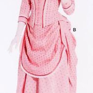 May include: A pink vintage dress with a dotted pattern, long sleeves, and a draped skirt. The dress features a high neckline, a bow, and white gloves. A matching hat completes the ensemble.