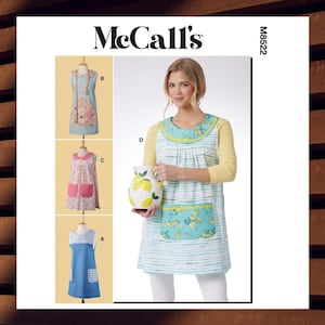 May include: McCall's sewing pattern featuring aprons with various designs. The aprons include floral and striped patterns, with details like pockets and contrasting trim. The image also shows a woman wearing an apron and holding a decorative pitcher.