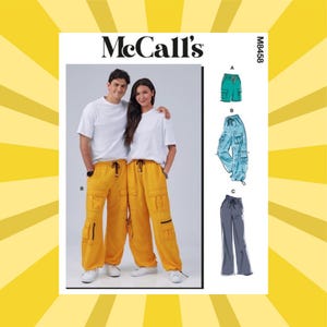 May include: McCall's M8458 sewing pattern envelope featuring illustrations of cargo pants and shorts. The front shows two individuals wearing yellow cargo pants with multiple pockets, drawstring waists, and black zippers, alongside technical sketches.