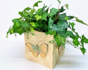 BUTTERFLY 5 1/2" sq. POTTERY CACHEPOT has a Raised Weathered Cream Finish with a Large Raised Relief Earthtone Butterfly on each Side