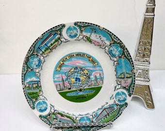 1964-1965 New York WORLD'S FAIR Souvenir Plate is a Collectible 7 1/8" Glazed Ceramic Dish w/Blue & Green Illustrations of Fair Highlights