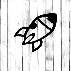 May include: A black and white cartoon rocket ship with a single window and a tail fin. The rocket ship is on a white wooden background.