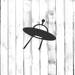 May include: A black silhouette of a flying saucer against a white woodgrain background.