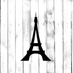 May include: A black silhouette of the Eiffel Tower against a white woodgrain background.