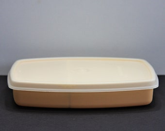 Klein vintage tupperwarebakje met 2 vakken.  Oogstgoudkleurige tupperwarecontainer met deksel. Zeer schoon.  Geweldige vintage staat.