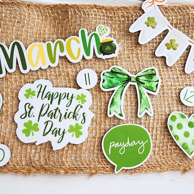 May include: A set of St. Patrick's Day themed stickers featuring a green shamrock, a pot of gold, a green bow, a green speech bubble with the word "payday" written in white, and a white sticker with the text "Happy St. Patrick's Day" in black with green shamrocks.