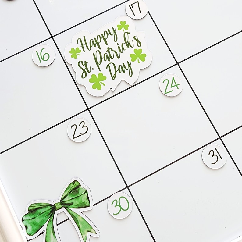 May include: A white calendar with green numbers and a green and white sticker that says "Happy St. Patrick's Day" with shamrocks.