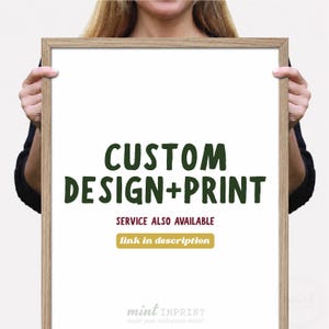 May include: A framed print with the words "CUSTOM DESIGN+PRINT" in dark green. Below, it reads "SERVICE ALSO AVAILABLE" with a gold box that says "link in description". The bottom of the print has the words "mint IMPRINT" and "make your milestones mint!"