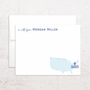 May include: White stationery set featuring a note card and envelope. The note card has the text "a note from Morgan Miller" in a handwritten font. A light blue watercolor map of the United States is on the bottom left, with the Villanova University logo.