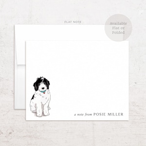 May include: A white stationery card with a black and white illustration of a dog wearing a blue collar with a red heart tag. The text "a note from POSIE MILLER" is printed in the bottom right corner, accompanied by a matching envelope.
