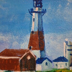 May include: A painting of a lighthouse with a red brick base and a white and blue tower. The lighthouse is surrounded by smaller buildings with white and blue paint. The sky is a light blue with white clouds.