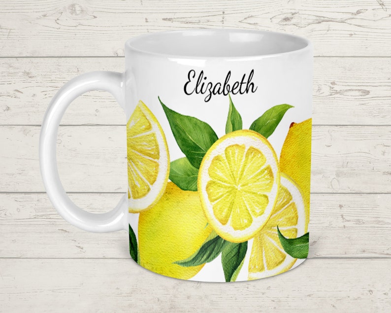 May include: White ceramic mug with a lemon design and the name "Elizabeth" printed on the front.