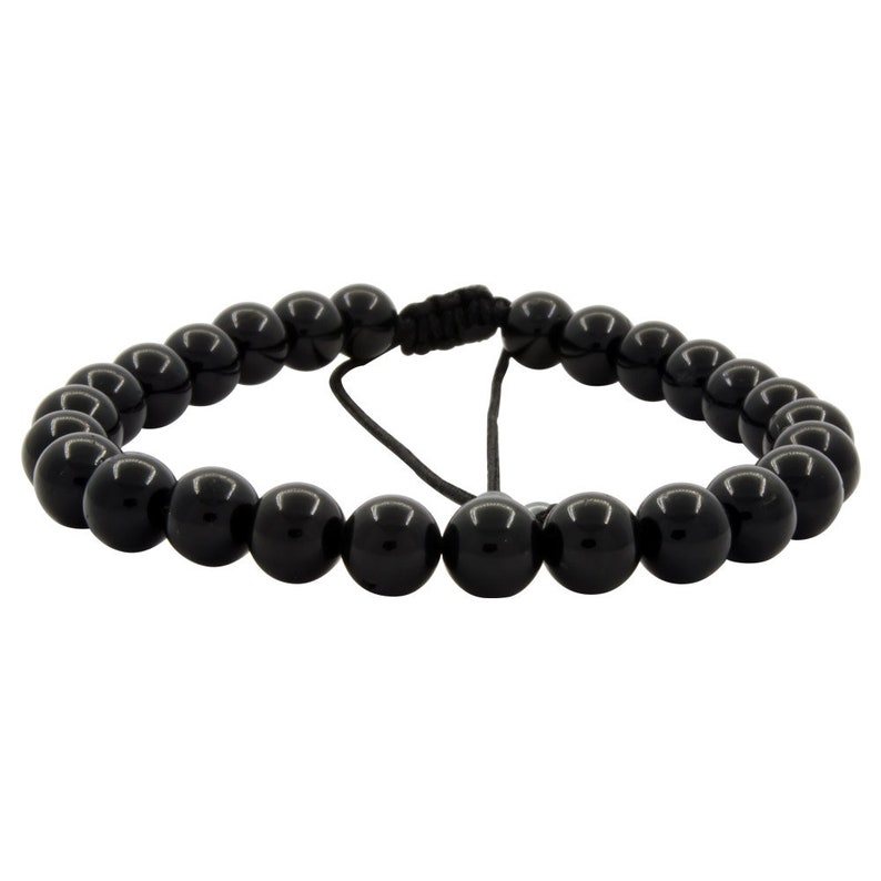 Peut inclure: Un bracelet noir en perles avec une fermeture en cordon noir.