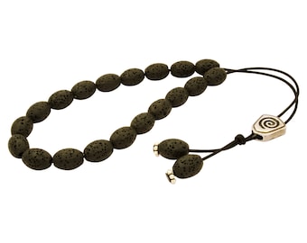 May include: A black lava stone mala necklace with a silver charm featuring a spiral design.