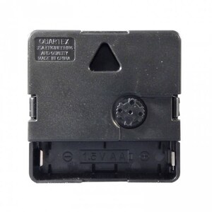 May include: A black clock movement with a 1.5V AA battery compartment. The movement has a small triangle cutout and the text "QUARTEX USA ENGINEERING AND QUALITY MADE IN CHINA".