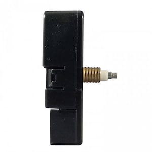 May include: A black clock movement with a gold-colored winding stem and a white plastic washer.