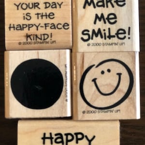 May include: Set of five wooden rubber stamps with various messages, including "Hope your day is the happy-face kind!" and "You make me smile!"