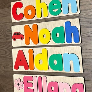 May include: Four wooden name puzzles with colorful letters. The names are Cohen, Noah, Aidan, and Elliana. The puzzles are perfect for children to learn their names and practice their fine motor skills.