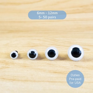 以下が含まれることがあります： 黒い瞳と白い縁取りのある4つのプラスチック製のクラフトアイ。直径は6mmから12mmです。画像には「6mm - 12mm 5-50 pairs」と「Duties Pre-paid for USA」と書かれています。