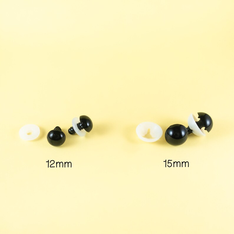 May include: Two sets of black plastic safety eyes for stuffed animals. The set on the left is 12mm in diameter and the set on the right is 15mm in diameter.