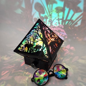 The Wonderland Shadow Lamp staged next to a pair of kaleidoscope glasses for size scaling.