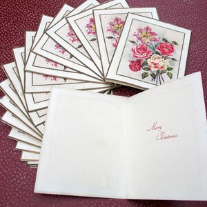 May include: A stack of vintage Christmas cards with a floral design and the words "Merry Christmas" on the front.