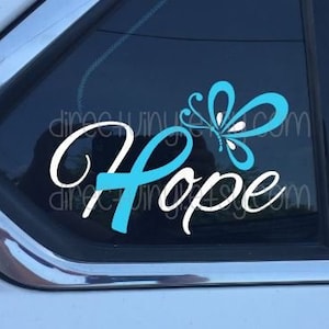 May include: A car window decal with a blue butterfly and the word "Hope" in white lettering. The butterfly has a white center and blue wings.