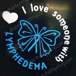 May include: A black background with a white heart, a blue butterfly with a blue ribbon, and the text "I love someone with Lymphedema".