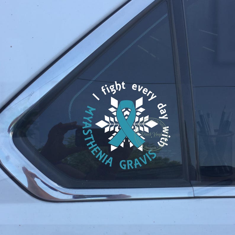 May include: A white and teal vinyl decal applied to a car window. The design features a central teal awareness ribbon over a white snowflake graphic, surrounded by the text I fight every day with MYASTHENIA GRAVIS in white and teal.