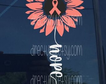 Könnte beinhalten: Eine rosa Sonnenblume mit einem rosa Band in der Mitte und dem Wort "Hope" in kursiv darunter.