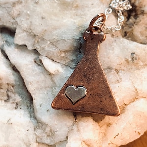 May include: A copper-coloured necklace with a silver heart charm in the shape of a flask.
