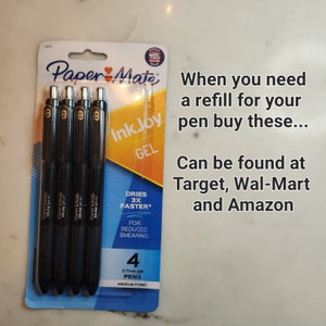 May include: A pack of four black Paper Mate InkJoy Gel pens with a medium point and 0.7mm gel. The packaging says "Dries 3X Faster" and "For Reduced Smearing".