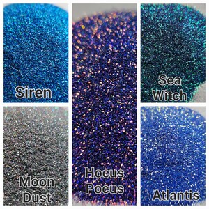 May include: Six different colors of iridescent glitter, labeled "Siren", "Sea Witch", "Moon Dust", "Hocus Pocus", and "Atlantis".