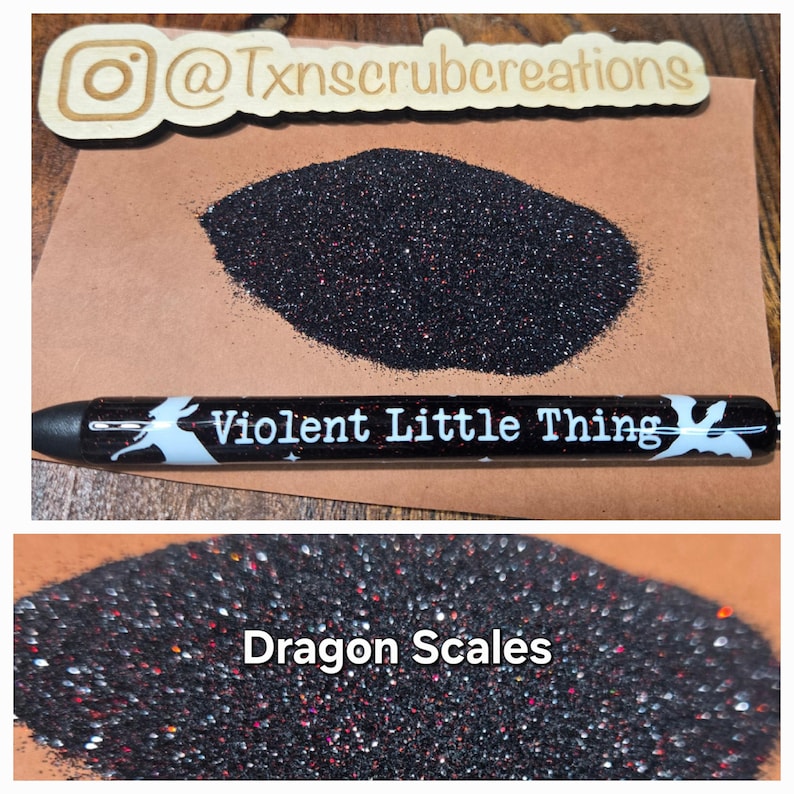 May include: Two samples of black glitter with red and silver flecks. The first sample is labeled "Violent Little Thing" and the second sample is labeled "Dragon Scales".