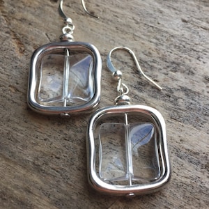 Silver metal alloy earrings and chic transparent resin charm