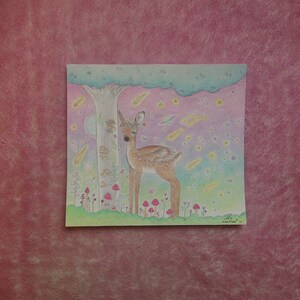 May include: A hand-drawn illustration of a deer with a flower crown standing in a forest with a tree, mushrooms, and a starry sky. The deer is brown and white with a pink nose and hooves. The sky is a gradient of pink, purple, and blue with white stars and shooting stars.