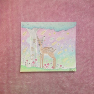 May include: A hand-drawn illustration of a deer with a flower crown standing in a forest with a tree, mushrooms, and a starry sky. The deer is brown and white with a pink nose and hooves. The background is a gradient of pink, blue, and green.