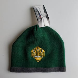 May include: Green knit beanie with a gray brim and a yellow embroidered logo that says "Knibb High Football".