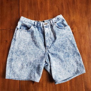 May include: A pair of light blue acid wash denim shorts with a high waist and five pockets.