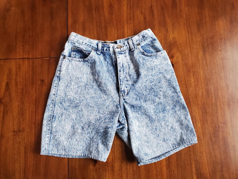 May include: A pair of light blue acid wash denim shorts with a high waist and five pockets.