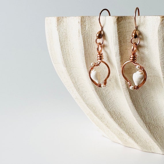 Seashells in hammered copper earrings.