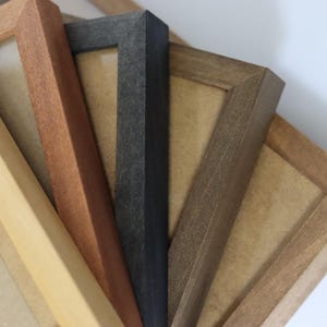 May include: Four different picture frames made of wood. The frames are in various shades of brown, black, and natural wood. The frames are all different sizes and have a simple design.