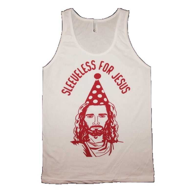 May include: White tank top with a red graphic of Jesus wearing a red and white polka dot party hat. The text "Sleeveless for Jesus" is written in a red semi-circle around Jesus' head.