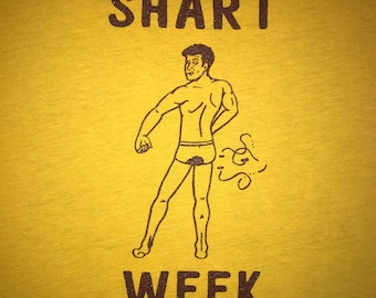 May include: A yellow t-shirt with a black line drawing of a person in underwear with a brown swirl coming out of their backside. The text "SHART WEEK" is printed on the shirt.