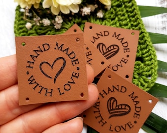 May include: Brown leather square tags with four holes and the text "HAND MADE WITH LOVE" in a circle with a heart inside.