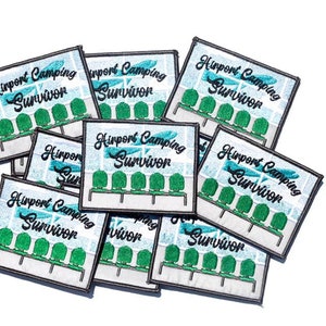 May include: A stack of nine embroidered patches with the text "Airport Camping Survivor" and a graphic of a row of airport seats. The patches are white with black text and green seats.